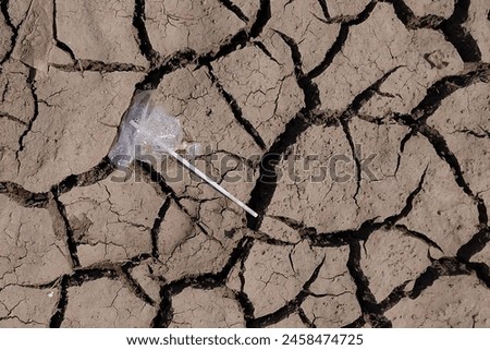 Similar – Image, Stock Photo Plastic straws thrown in ocean. Pollution concept. Flat lay on pink background