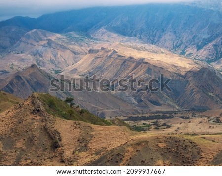 Travel in the sandy mountains. Mountain texture, mountain terrain. Colorful sunny morning landscape with silhouettes of big rocky mountains and epic deep gorge.  Photo stock © 