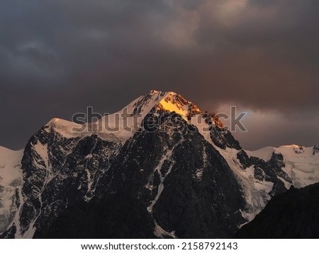 Similar – Image, Stock Photo Snowy mountains lit by sunlight light in evening