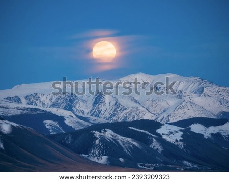 Similar – Foto Bild Vollmond über verschneiten Bergen