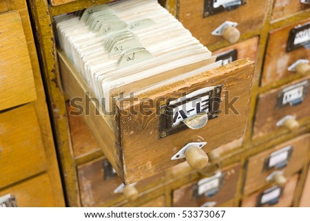 Old wooden card catalogs with one opened drawer