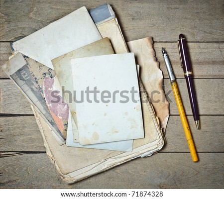 vintage notebook old papers and pens on a wooden table