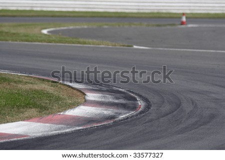 Kerbs at a motor sport circuit with heavy rubber scuffing from racing tires.