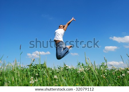 black girl jumps on a background of sky