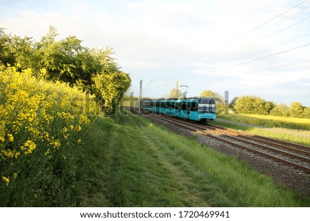 Similar – Image, Stock Photo Passenger train and rapeseed field. Spring landscape at sunrise