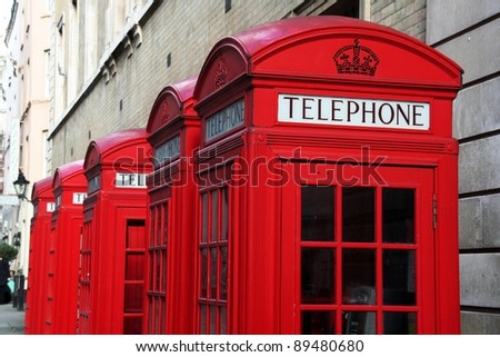 Five red telephone boxes  in London