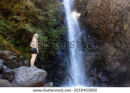 Adult Woman hiker at Norvan Falls and river stream in the natural canyon during the summer time. Canadian Nature Background. Lynn Valley, North Vancouver, BC, Canada. Stok fotoğraf © 