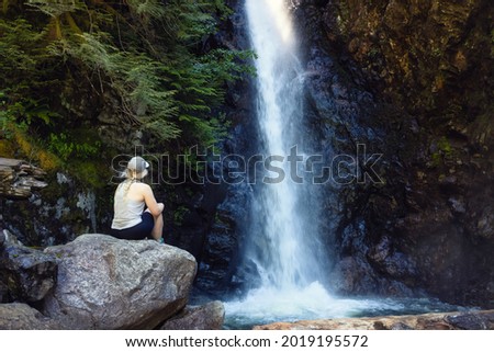 Adventurous Woman hiker at Norvan Falls and river stream in the natural canyon during the summer time. Canadian Nature Background. Lynn Valley, North Vancouver, British Columbia, Canada. Stok fotoğraf © 