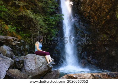 Adult Woman hiker at Norvan Falls and river stream in the natural canyon during the summer time. Canadian Nature Background. Lynn Valley, North Vancouver, BC, Canada. Stok fotoğraf © 