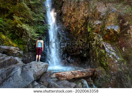 Adult Woman hiker at Norvan Falls and river stream in the natural canyon during the summer time. Canadian Nature Background. Lynn Valley, North Vancouver, British Columbia, Canada. Stok fotoğraf © 