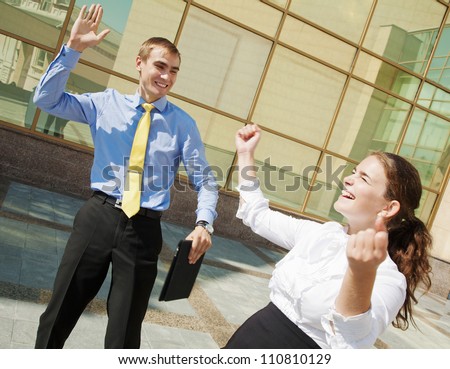 Success concept: businesspeople raising hands and clapping