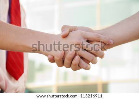 handshake of two persons near the building
