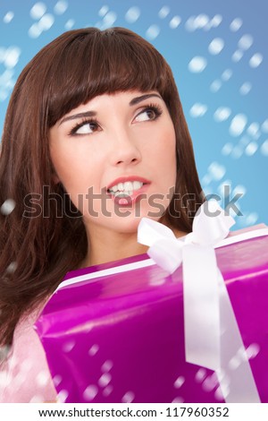 Women with gift box bit her lip