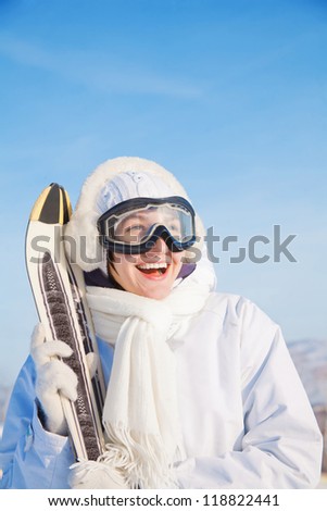 Smiling skier woman sky background