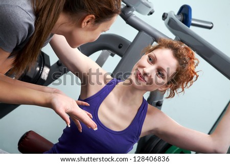 Young woman speaking with her friend water in sport club