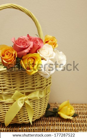 Beautiful fresh roses in yellow basket