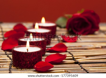 Row of candles with rose petals