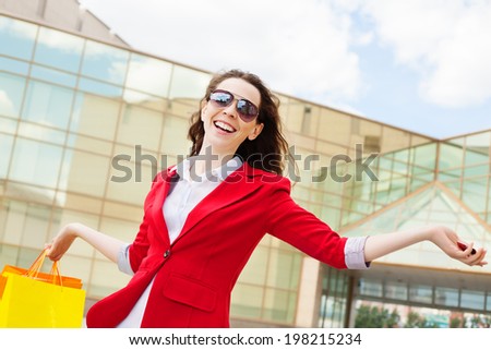 Female shopper with a credit card looking very happy