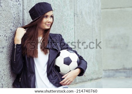 Portrait of beautiful smiling girl with soccer ball