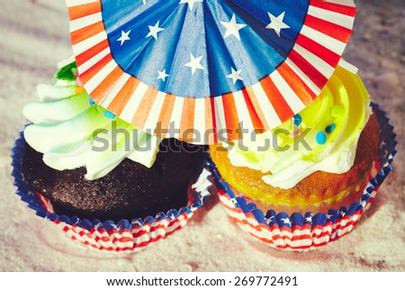 Patriotic holiday cupcakes with American flag umbrella  decorated for july 4th.