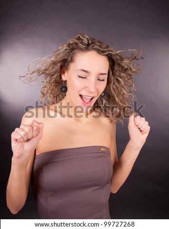 Portrait of beautiful woman screaming over black background