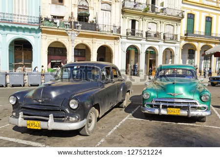 HAVANA-SEP 7: Old Plymouths parked front of the Capitol on Sep 7, 2011 in Havana. Before a new law issued on October 2011, cubans could only trade vintage cars that were on the road before 1959.
