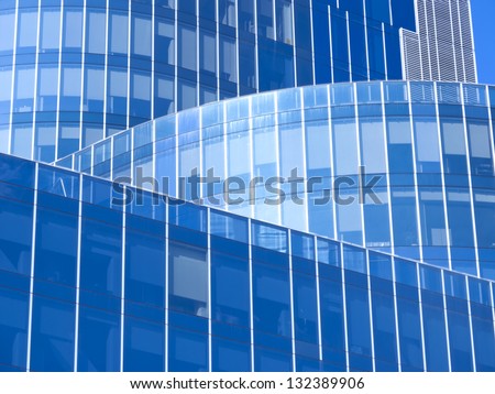 Modern office building with blue glass facade futuristic