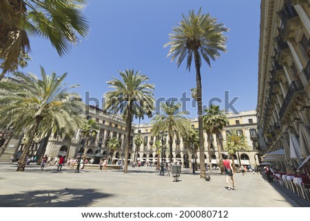 BARCELONA - JUNE 12: Tourists on Plaza Real on June 12, 2013 in Barcelona, Spain. The Royal Plaza is a square in the Gothic Quarter. Located next to La Rambla and is a well-known tourist attraction.