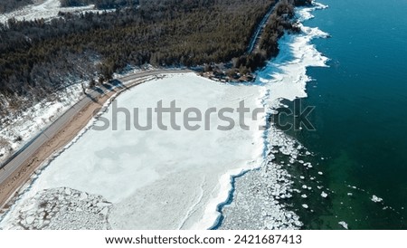 Similar – Image, Stock Photo Shoving snow on the roof. Remove snow from solar system