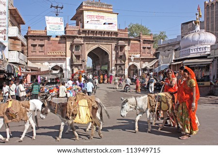 JODHPUR, INDIA - JANUARY 15: Unidentified locals shop at a market under the clock tower on January 15, 2012  in Jodhpur, India. Jodhpur is know as the blue city.
