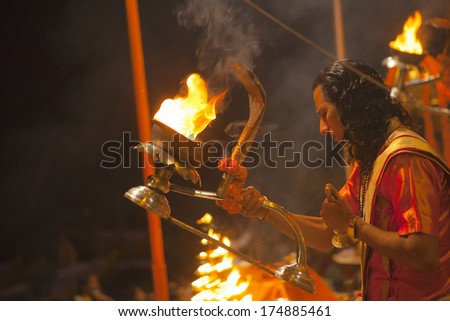 VARANASI, INDIA - November 25: An unidentified Hindu priest performs religious Ganga Aarti ritual (fire puja) at Dashashwamedh Ghat on November 25, 2012 in Varanasi, Uttar Pradesh, Central India