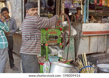 NEW DELHI - FEBRUARY 15: Man cooking and selling India\'s popular street reed juice on February 15, 2013 in New Delhi, India.