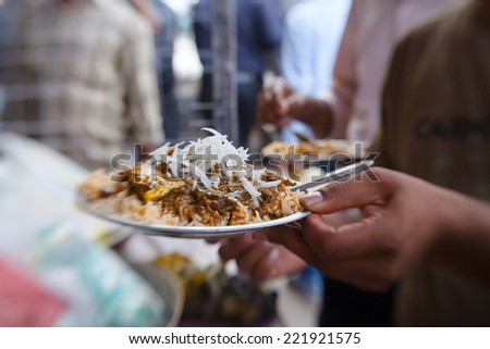 Street food wrapped in newspaper for sale to the crowds