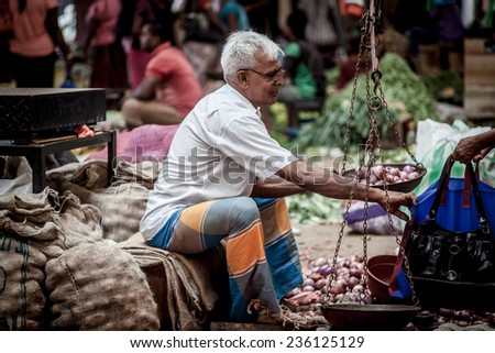 GALLE - April 17: Vendor selling fresh vegetables and fruits, 17 March 2014 in Galle, Sri Lanka. Many people buy fresh food on the street rather than at shops.