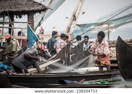 FORT KOCHI, INDIA - DECEMBER 20: fishermen fishing in their wooden boats in the early morning on December 20, 2012 in Fort Kochi, Kerala, India.