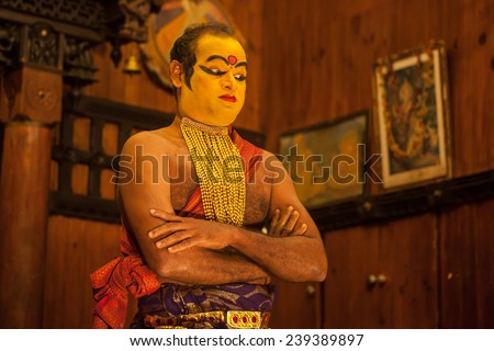 FORT COCHIN -  DECEMBER 7: Unidentified Kathakali performer applying face make-up prior to a performance on December 7, 2012 in South India. Kathakali is the ancient classical dance form of Kerala.
