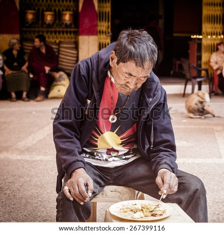NEW DELHI, INDIA - 25 February : Tibetian man having dinner  in Majnu-ka-tilla Tibet colony in Delhi during a protest by free Tibet February 25, 2014 in New Delhi, India.