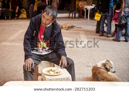 NEW DELHI, INDIA - 25 February : Tibetian man having dinner  in Majnu-ka-tilla Tibet colony in Delhi during a protest by free Tibet February 25, 2014 in New Delhi, India.