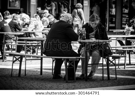 HAMBURG, GERMANY - MAY 29: cafe with people having dinner on Sunday, near the  St. Michael Cathedral  - one of the well known landmarks, on May 29, 2015 in Hamburg, Germany