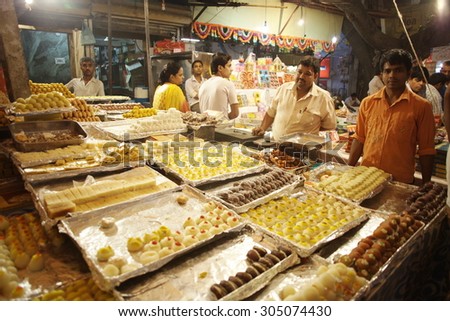 DELHI, INDIA - NOVEMBER 2:Vendors of famous indian sweets on famous Main Bazaar Road on November 2, 2013 in Delhi