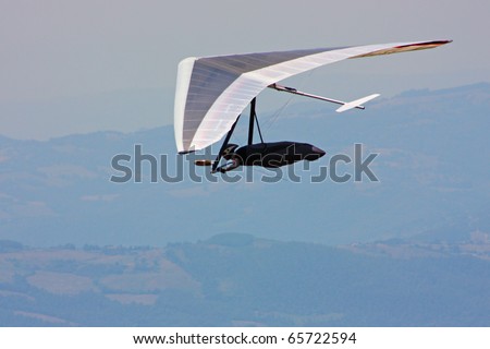 MONTE CUCCO, ITALY - AUGUST 12: Competitor of the Dutch Open-2010 hang gliding competitions takes part on the Monte Cucco mountain on August 12, 2010 near Cigillo, Italy.