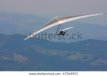 MONTE CUCCO, ITALY - AUGUST 12: Competitor of the Dutch Open-2010 hang gliding competitions takes part on the Monte Cucco mountain on August 12, 2010 near Cigillo, Italy.
