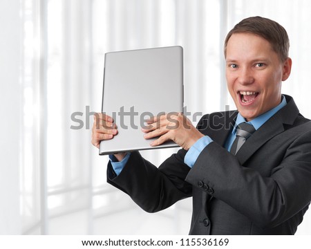 excited business man with his laptop computer. Isolated on white
