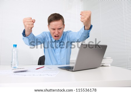 angry businessman with his laptop in office