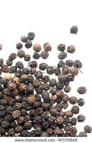Close up of black peppercorns in isolated white background