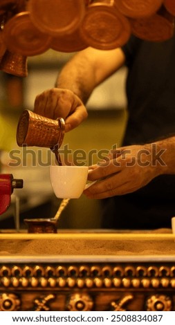 Similar – Image, Stock Photo Turkish espresso pot made of hammered metal stands for coffee preparation on the gas flame of the kitchen stove