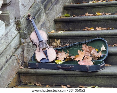 old broken violin on baroque stairs