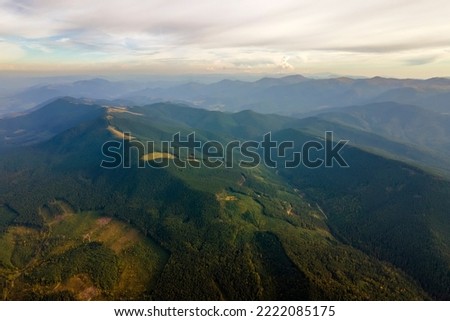 Similar – Image, Stock Photo Aerial view over a little town with wind wheels and a lake in the background of a german countryside.