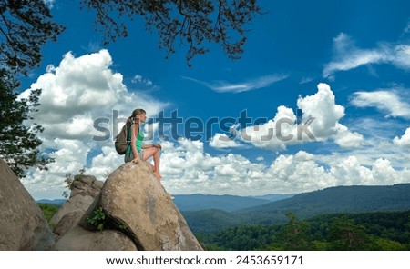 Similar – Image, Stock Photo Lone female hiker contemplating the clouds from the top of a mountain