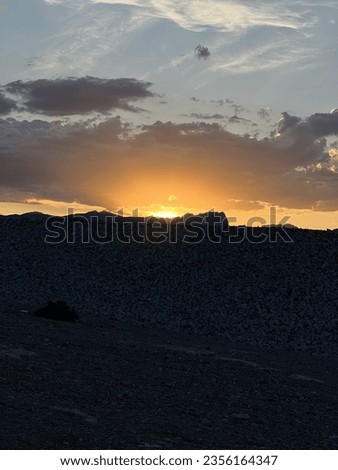 Similar – Image, Stock Photo The last rays of light come through the cloud cover. The vast land is already shrouded in darkness.
